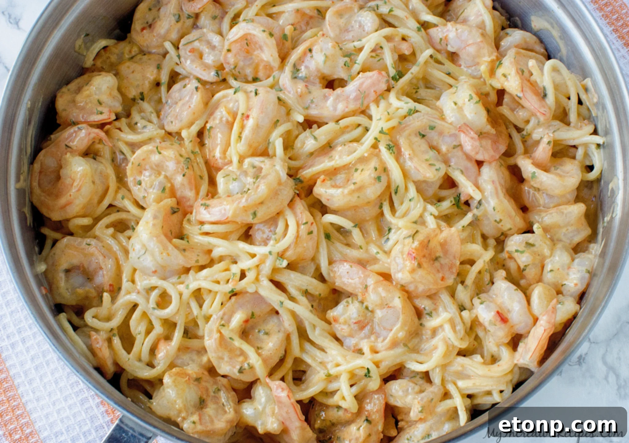 Cooked shrimp and chicken, ready to be added to the sauce.