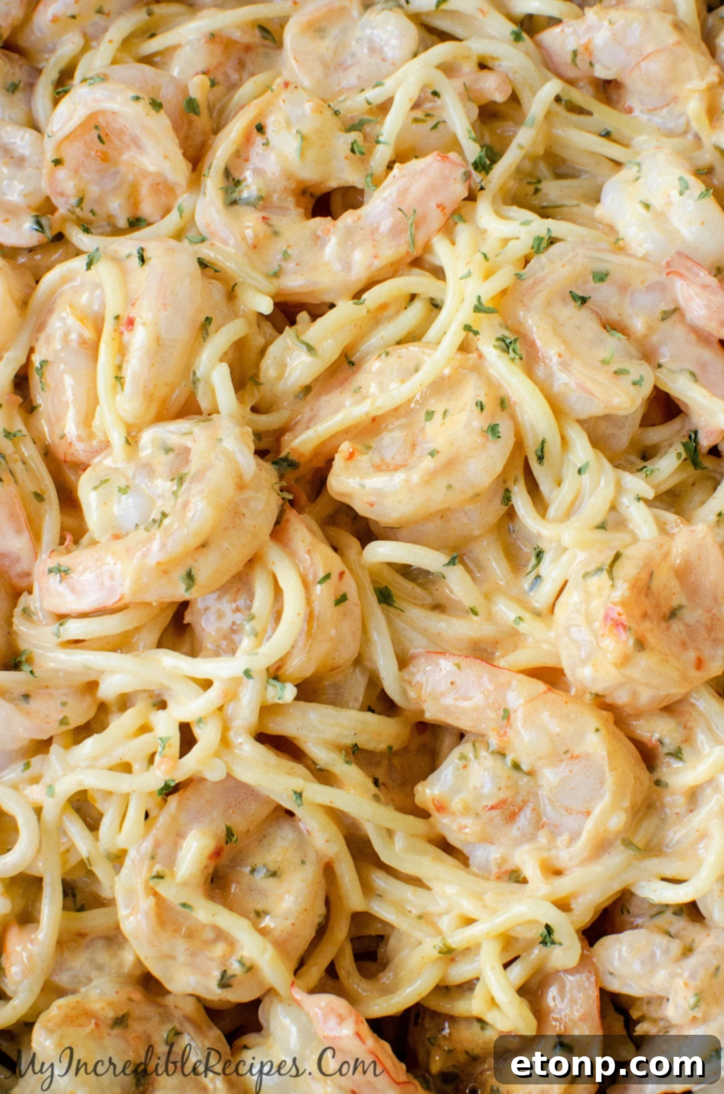 A large skillet with sizzling shrimp, cooked to perfection.