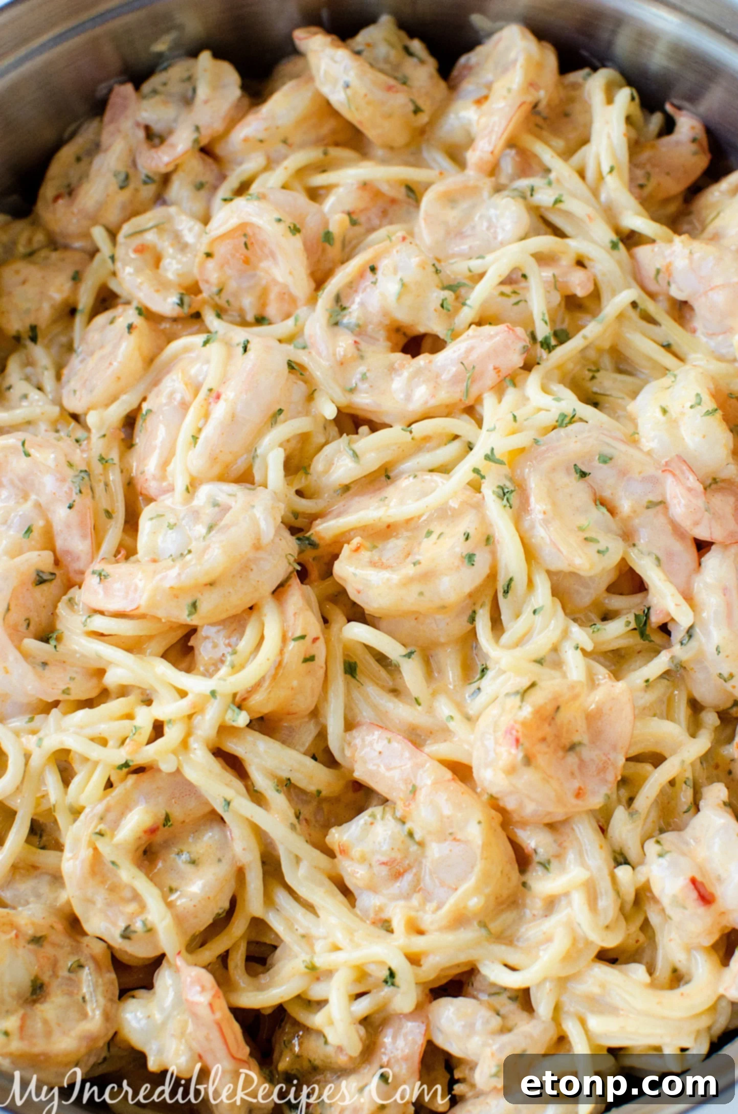 All ingredients combined: pasta, shrimp, and sauce, ready for tossing.