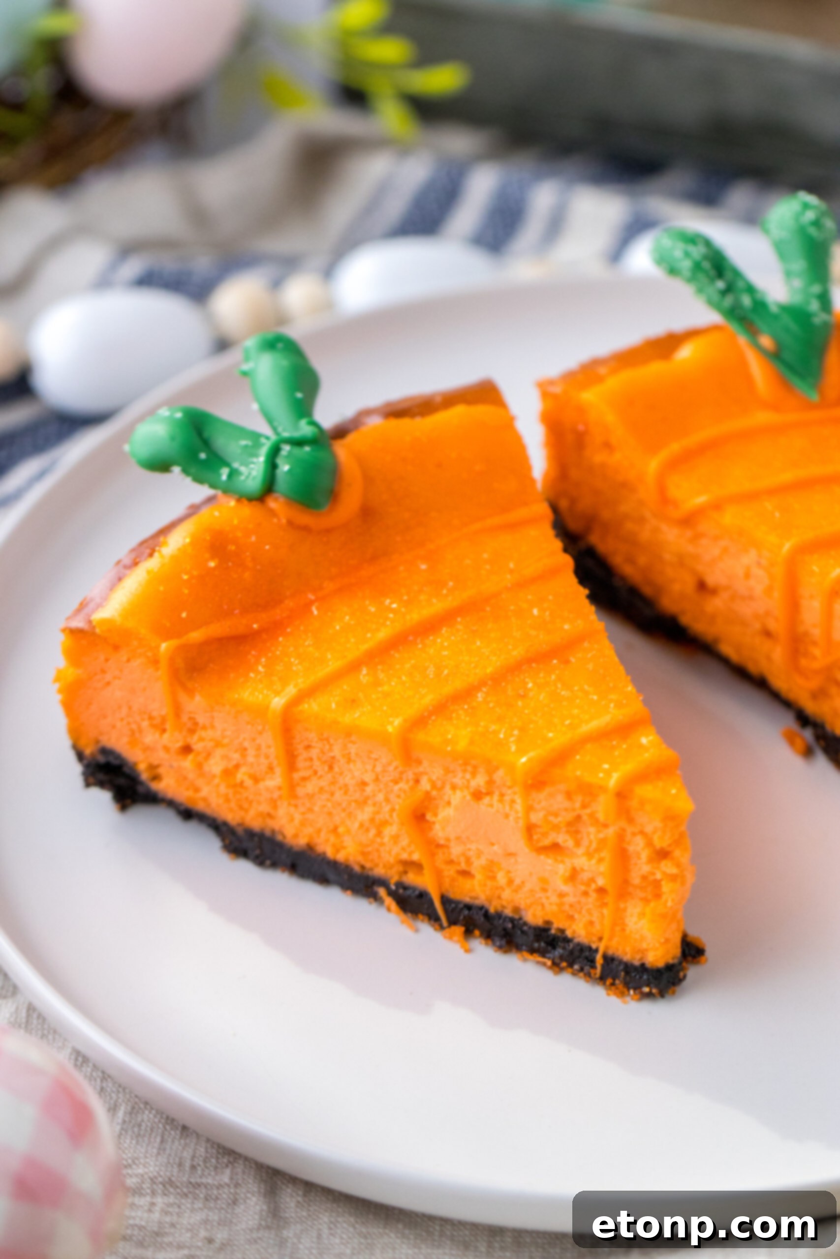 Carrot Cake Cheesecake 2 Two Cheesecake Carrots on a white plate.