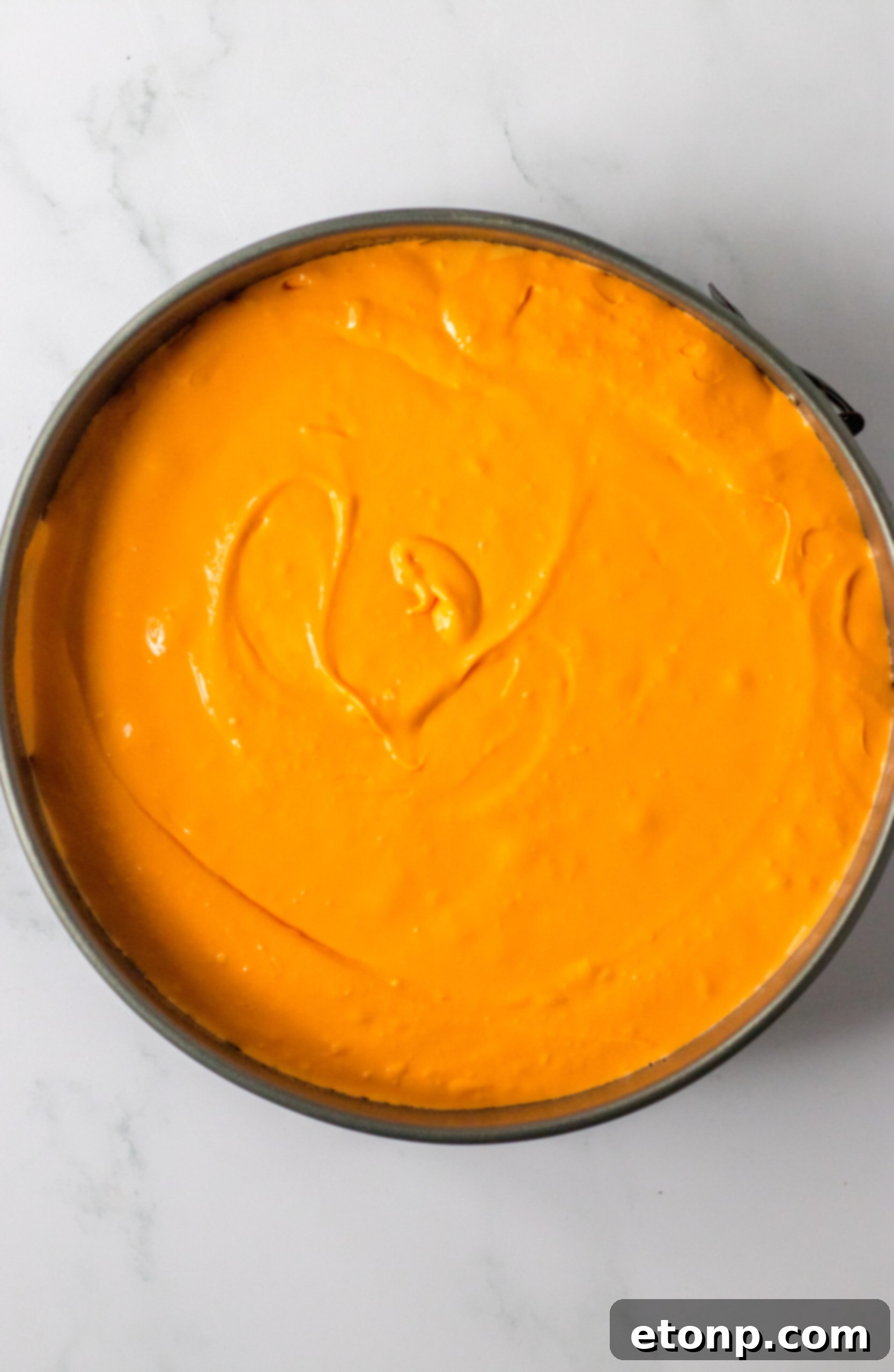 Carrot Cake Cheesecake 7 Adding orange food coloring to cheesecake batter