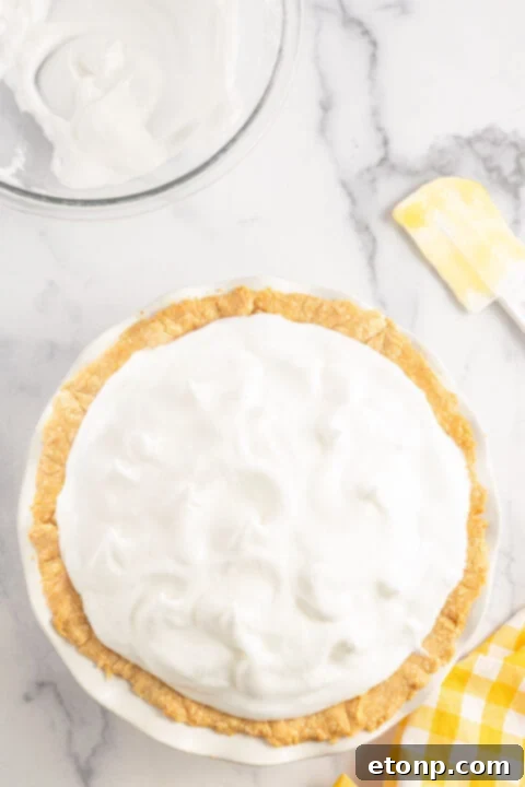 Final stage of preparation before baking the lemon meringue pie.
