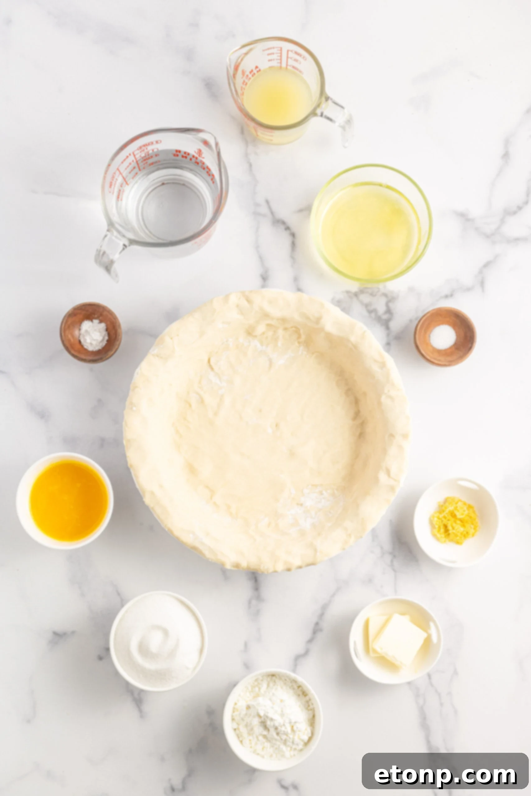 Overhead shot of all the fresh ingredients neatly arranged on a counter, ready for making lemon meringue pie.