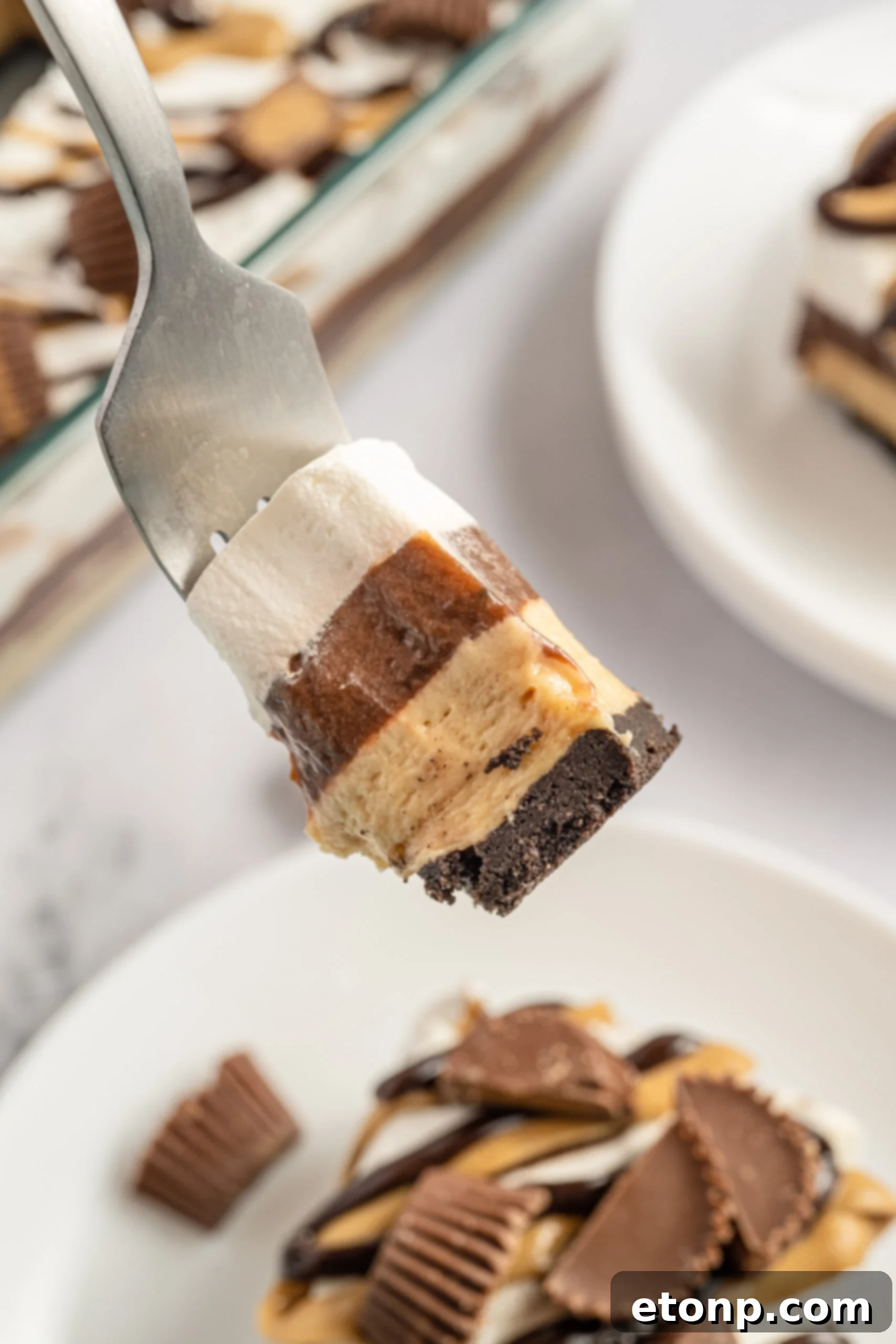 A fork removing a bite of chocolate lasagna. 