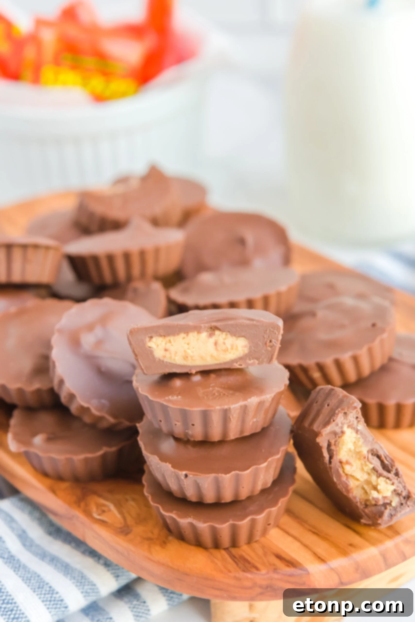 Homemade Peanut Butter Chocolate Cups 18 Another view of homemade Reese's Peanut Butter Cups on a wooden board, showcasing their rich color and appealing texture.