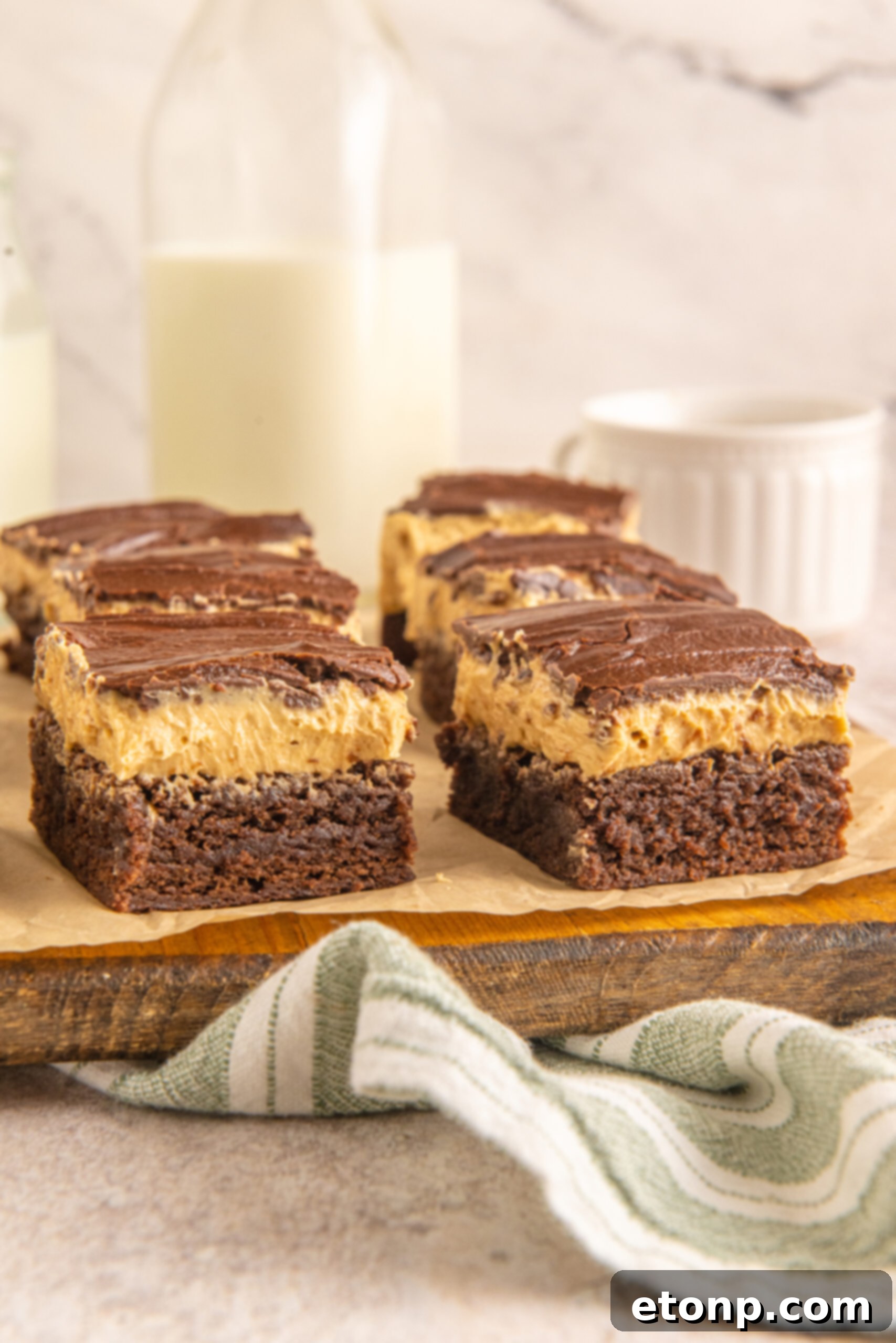 Side view of Buckeye Brownies on a wooden serving board. 