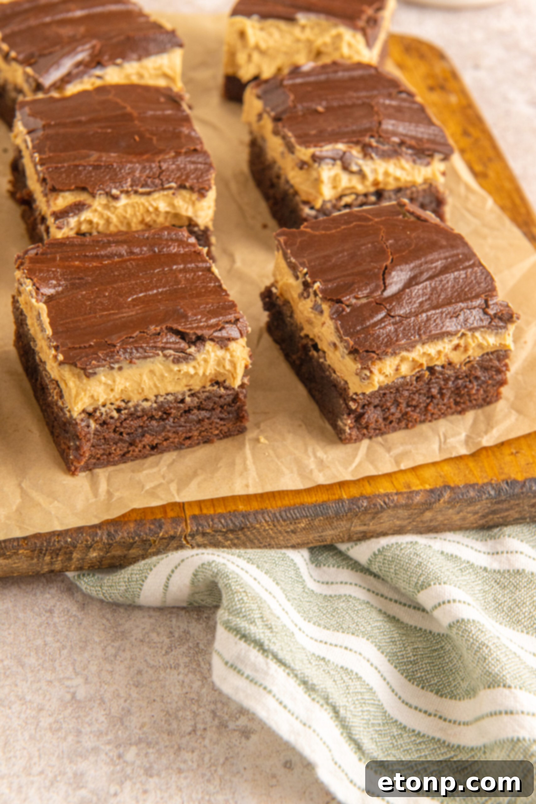 Side view of Buckeye Brownies on a wooden serving board. 