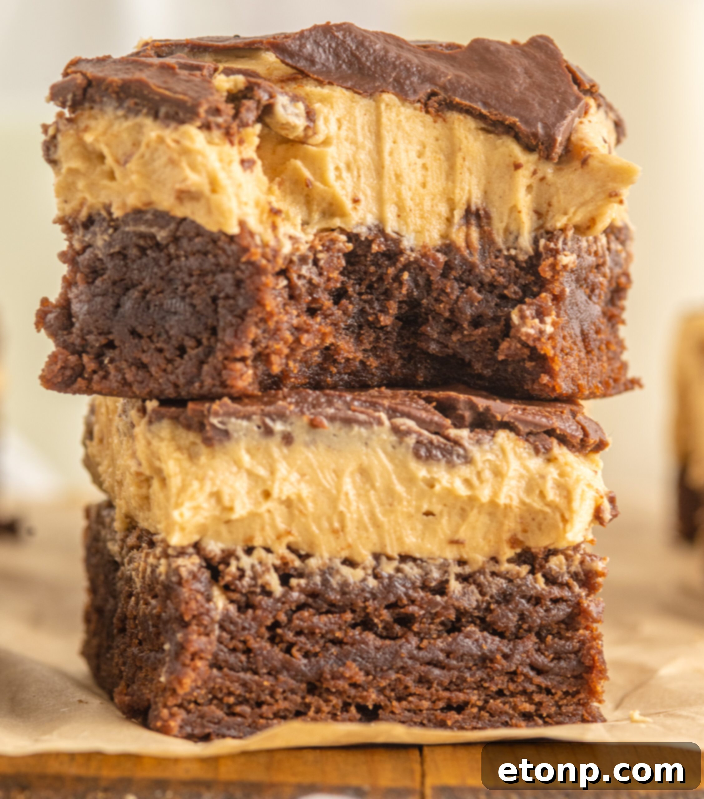 up close shot of two Buckeye Brownies stacked on top of each other with a bite removed from the top one. 