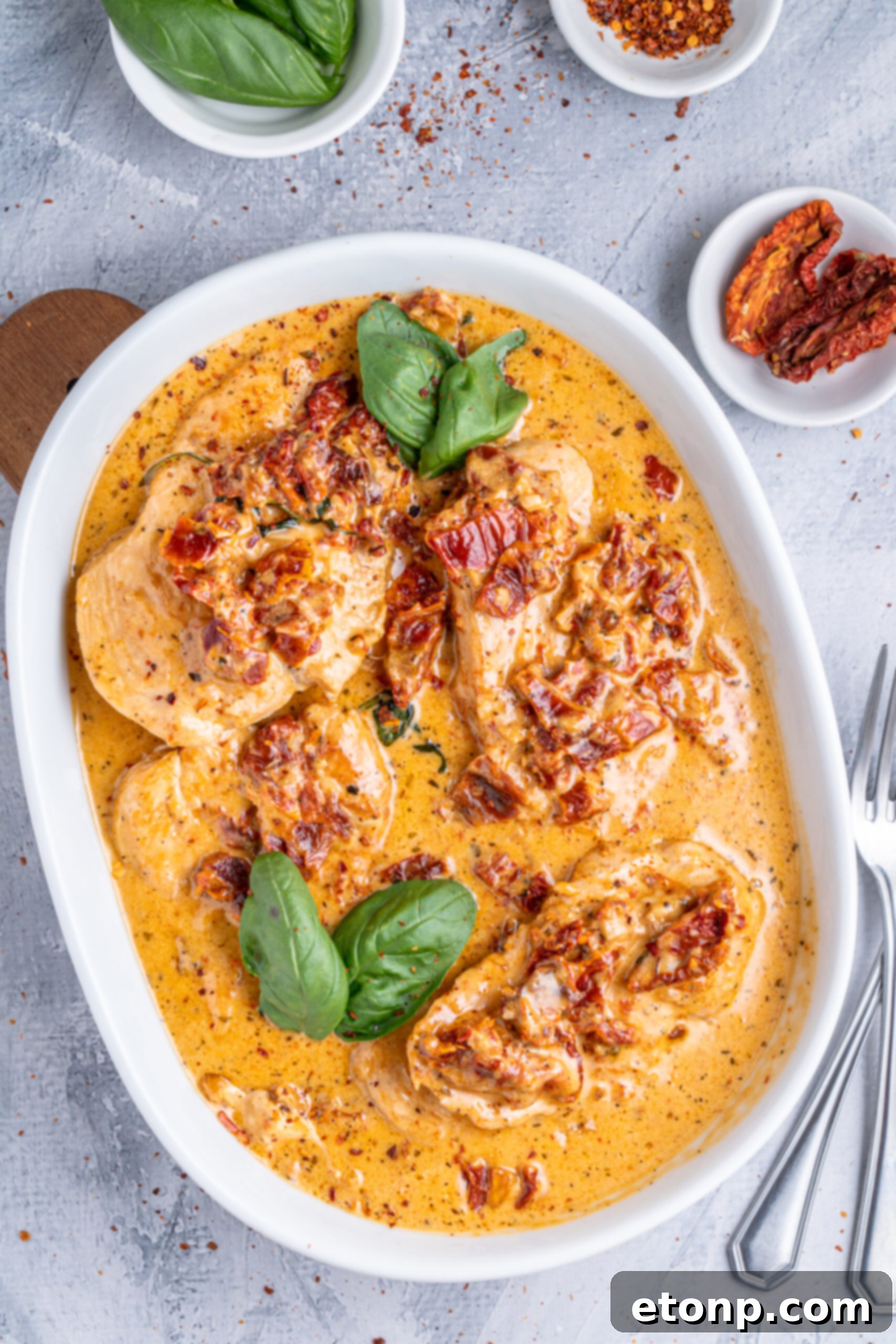 Heart-Winning Chicken 17 Marry Me Chicken in a white baking dish, garnished with fresh basil, presented elegantly.