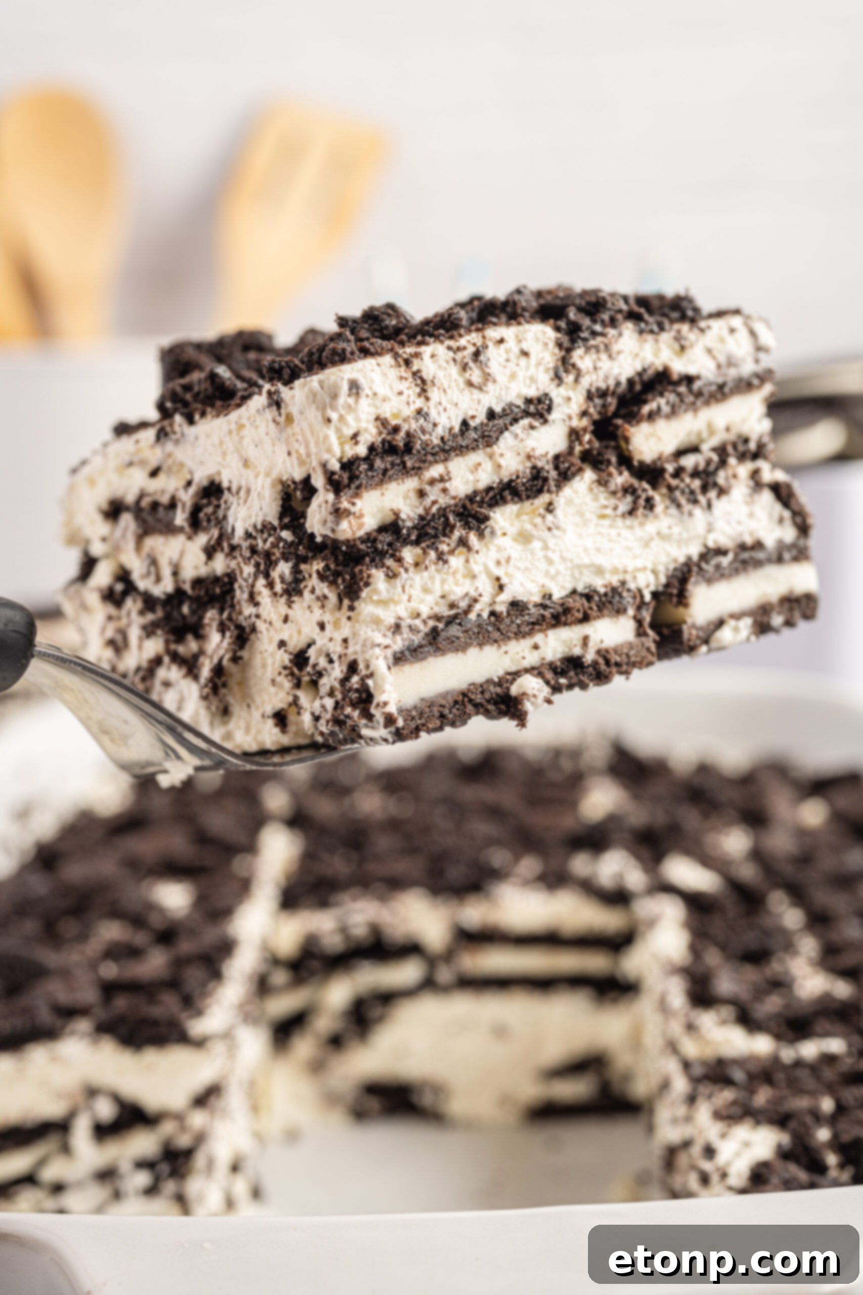 Oreo Cream Dream 2 Front view of a slice of Oreo Icebox Cake on a silver cake server.