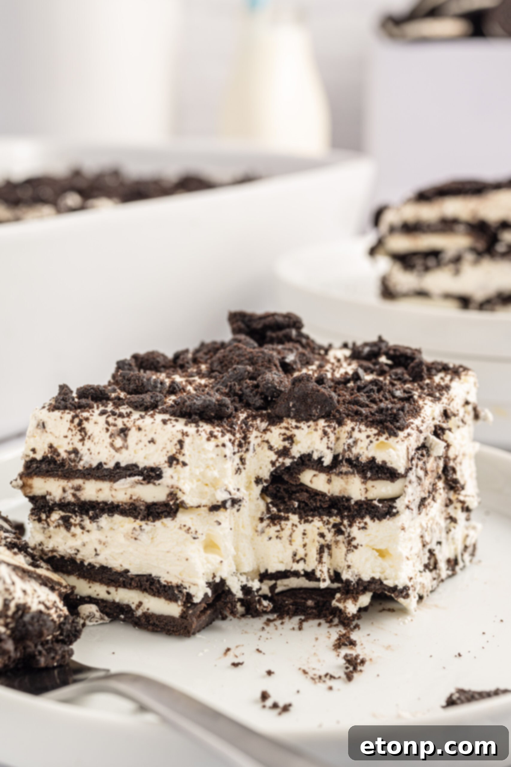 Oreo Cream Dream 17 Slice of the Oreo Icebox Cake on a white plate with a bite missing