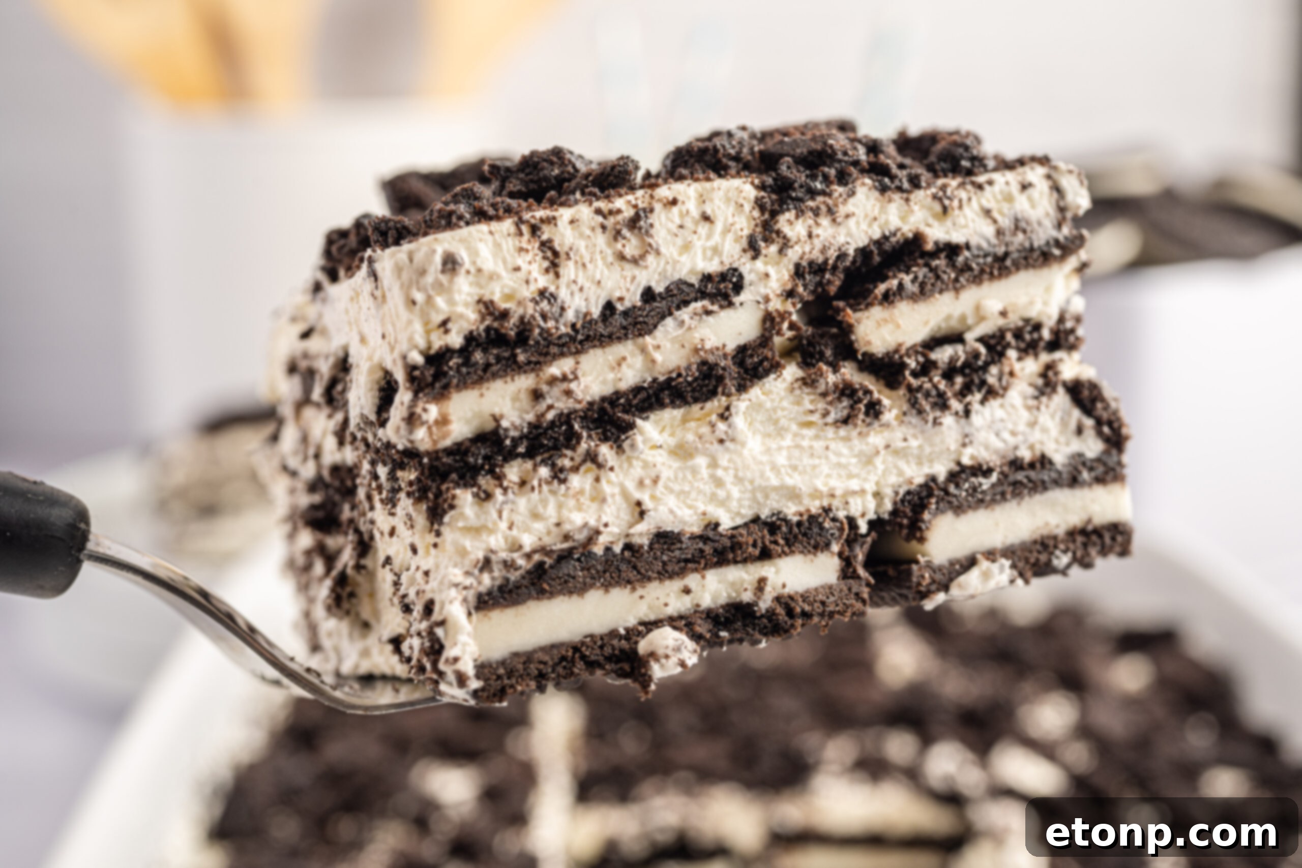 Oreo Cream Dream 18 Slice of the Oreo Icebox Cake being lifted out of the pan