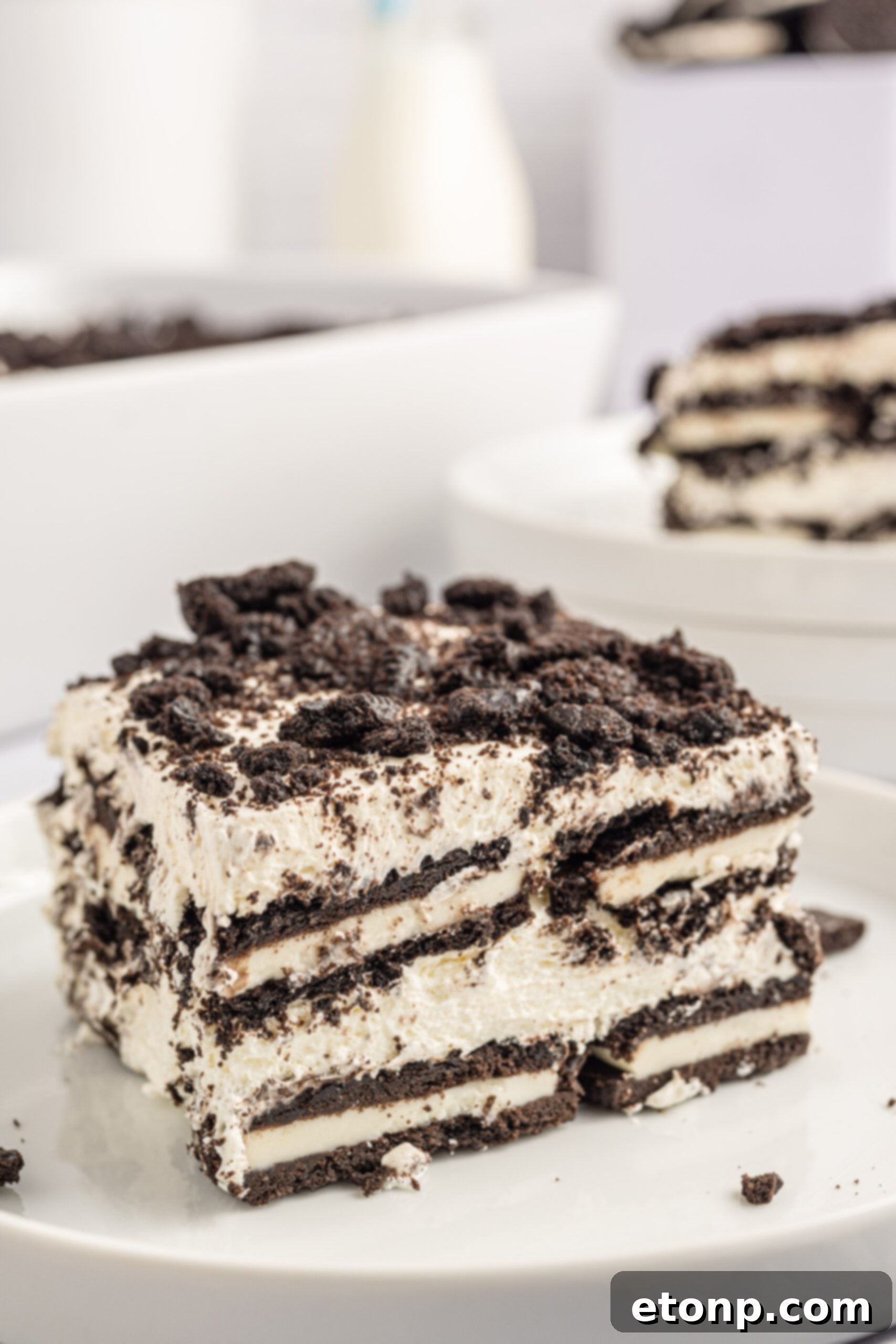 Oreo Cream Dream 20 Front view of a slice of Oreo Icebox Cake on a white plate.