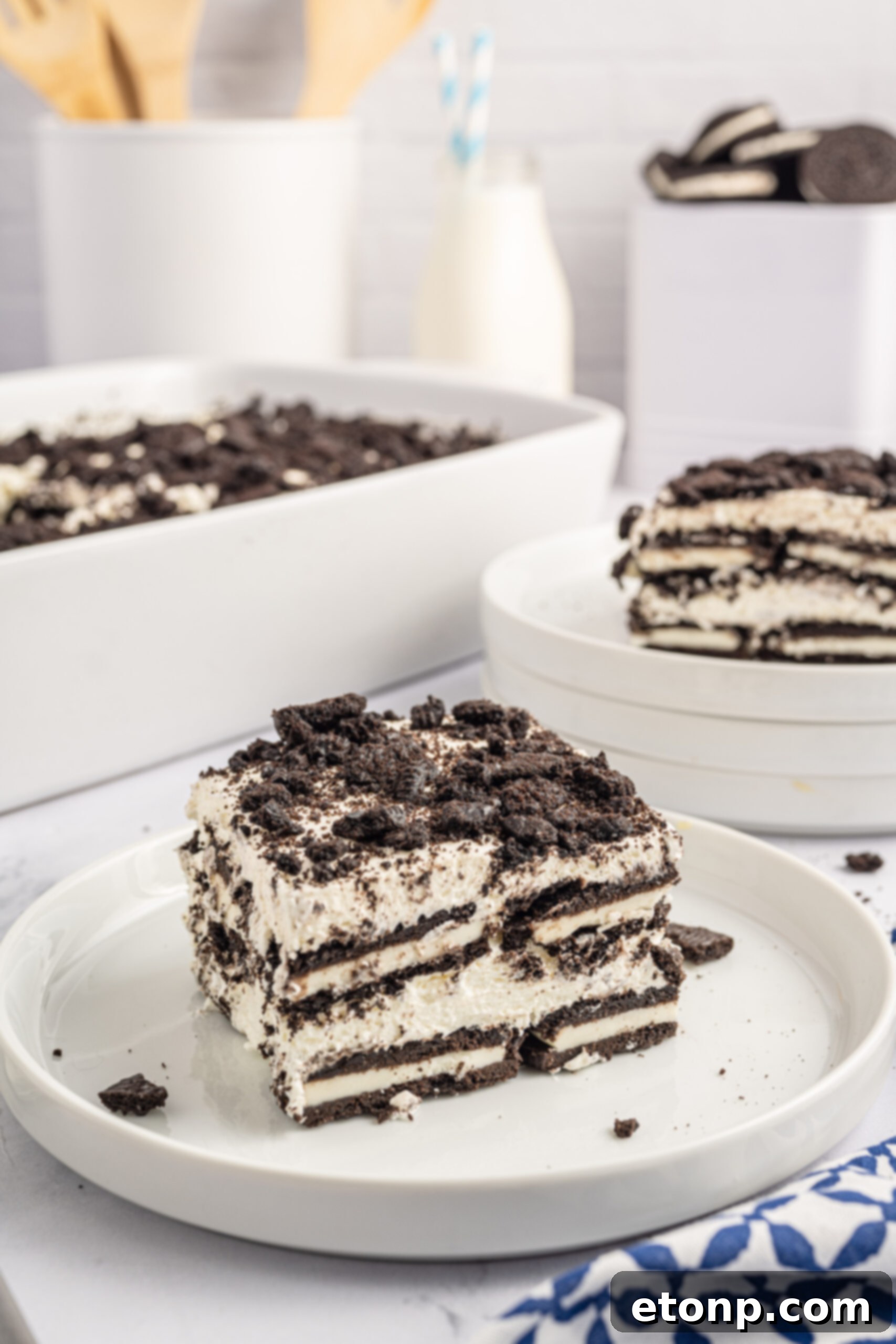 Oreo Cream Dream 21 Front view of a slice of Oreo Icebox Cake on a white plate.