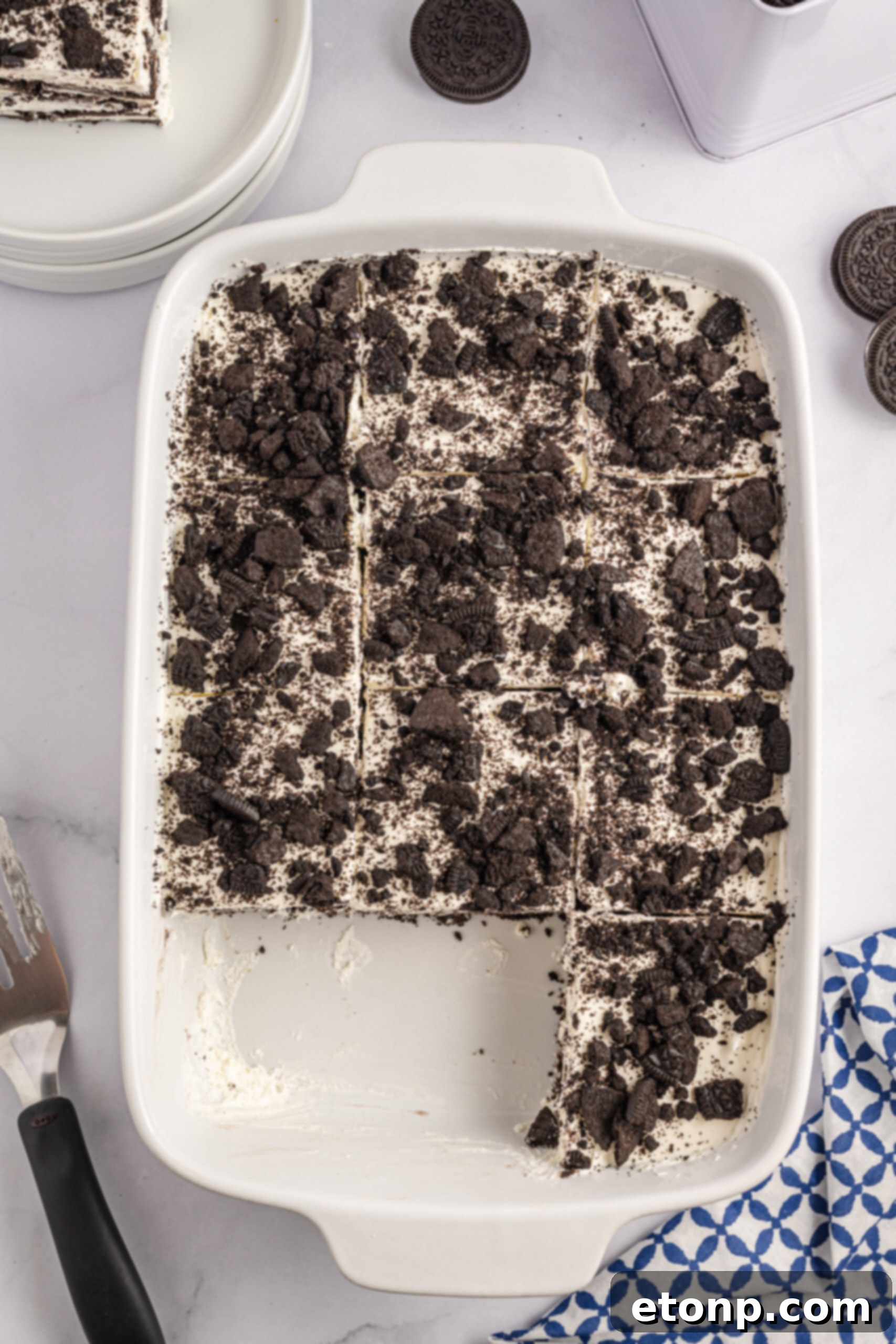 Oreo Cream Dream 8 Overhead view of Oreo Icebox Cake, cut into slices, in a white baking dish.