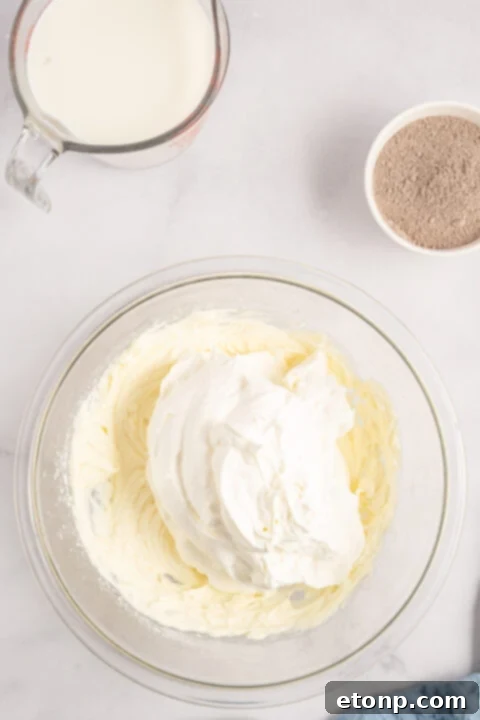 Pressing the Oreo crust into the dish.