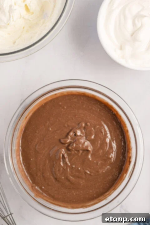 Mixing cream cheese and powdered sugar.