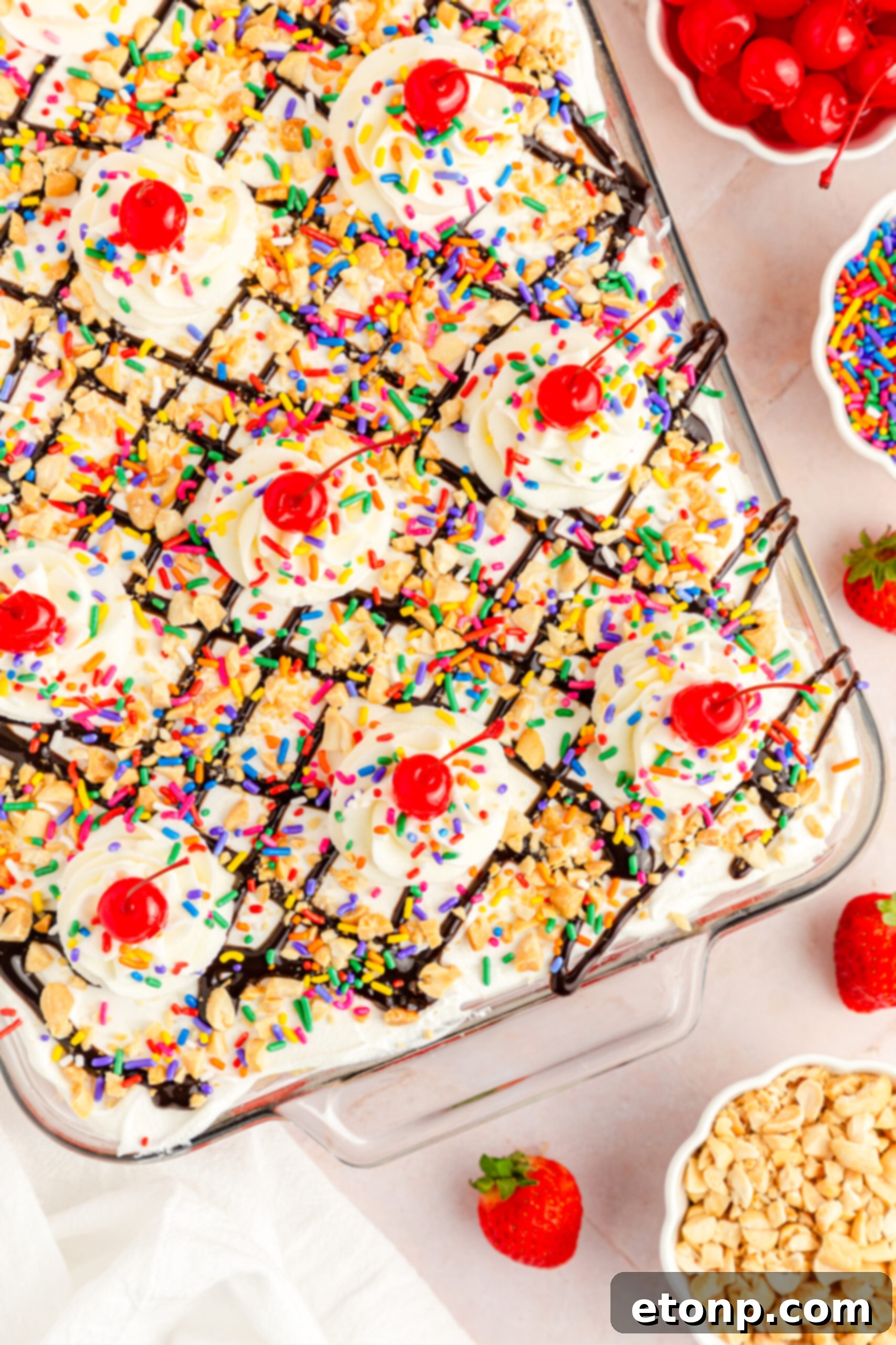 No-Bake Banana Split Bliss 4 Overhead view of No Bake Banana Split Cake in a clear baking dish, beautifully arranged.