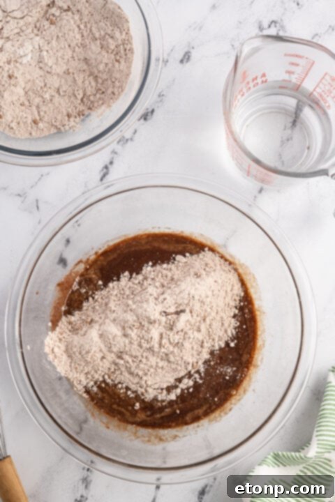 Step-by-step image of combining dry ingredients (flour, cocoa, baking powder, baking soda, salt) in a bowl for the Samoa cake batter.