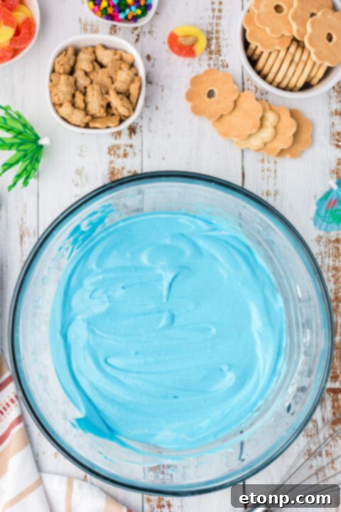 Close-up of a beach pudding cup showing the blue layer and cookie sand.