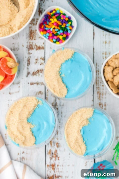An assortment of beach-themed pudding cups, showcasing various decorations.