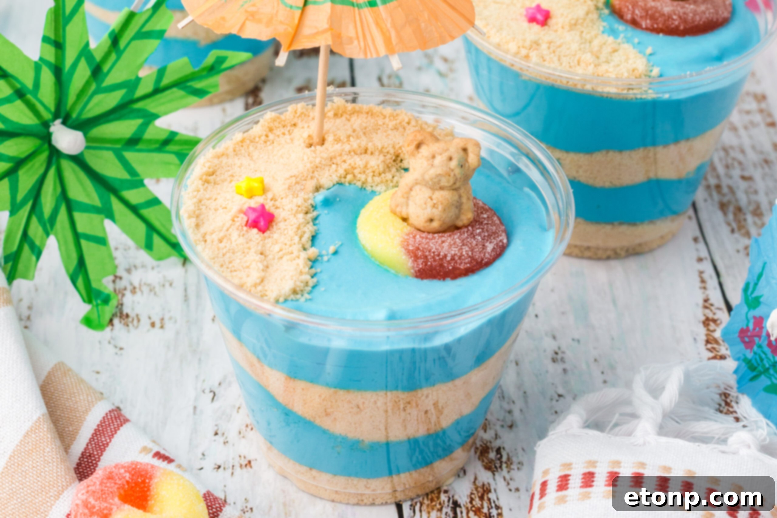Close up view of Beach Cheesecake Pudding Cups, beautifully decorated and ready to be served.