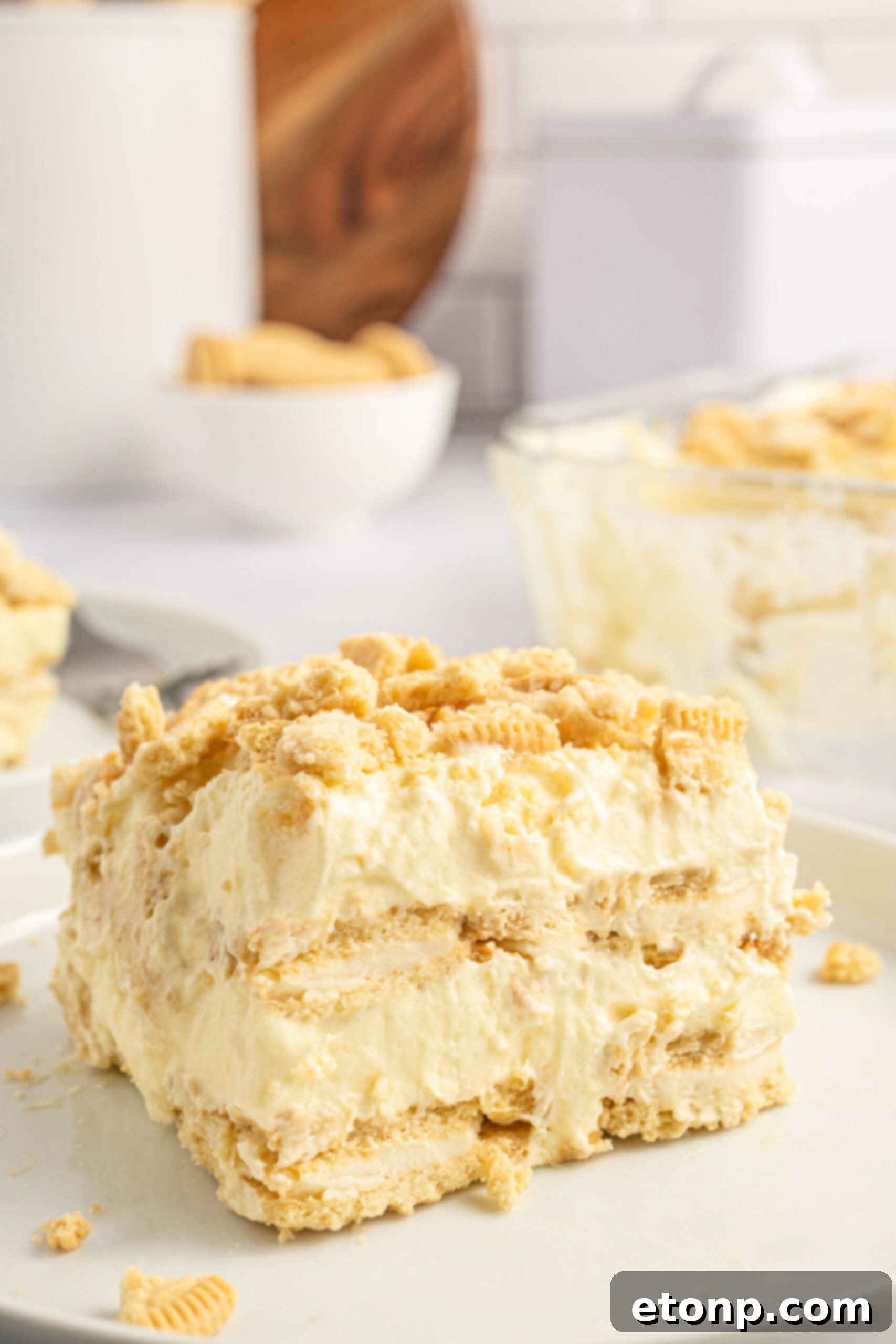 Front view of a slice of Golden Oreo Icebox Cake on a white plate, showcasing its beautiful layers.