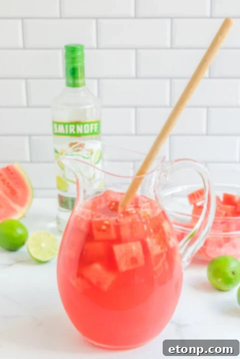 Pouring watermelon juice into a pitcher.