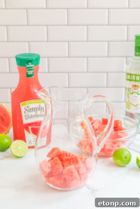 Watermelon cocktail being poured into a glass.
