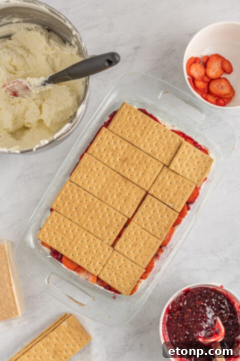 First layer of graham crackers in a baking dish, ready for filling.