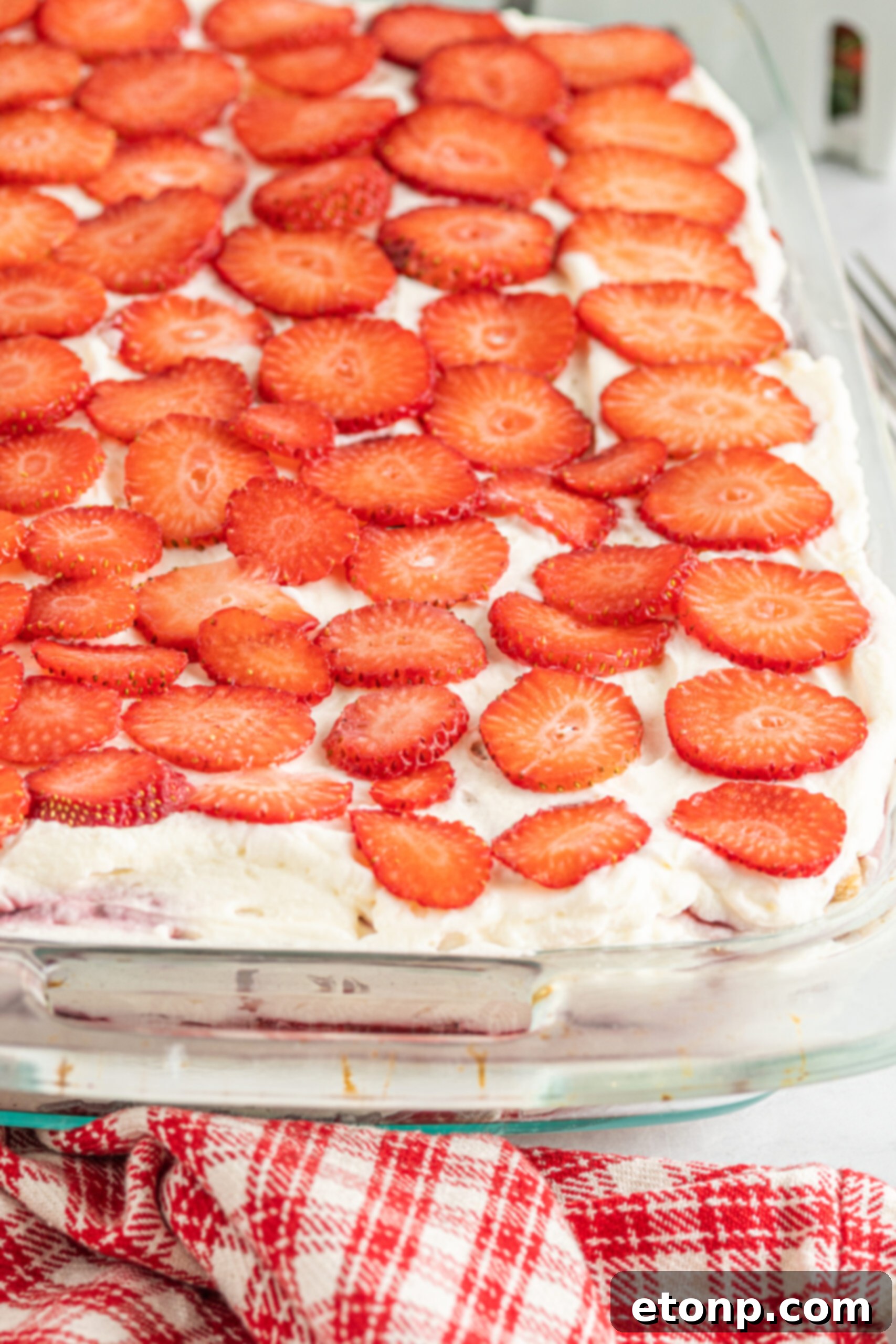 A stunning up-close view of the vibrant strawberry topping, perfectly sliced and arranged, inviting a delightful taste.