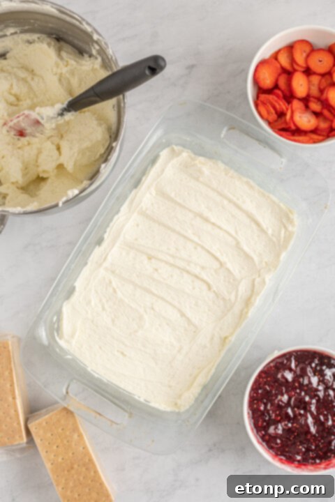 Cream cheese and powdered sugar being beaten together in a stand mixer.