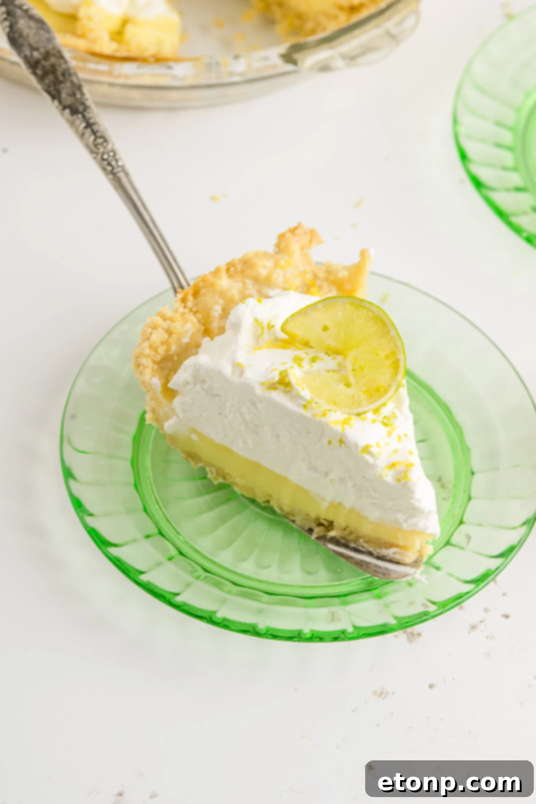 Salty Sweet Coastal Pie 8 A piece of Atlantic Beach Pie being placed on a green plate.