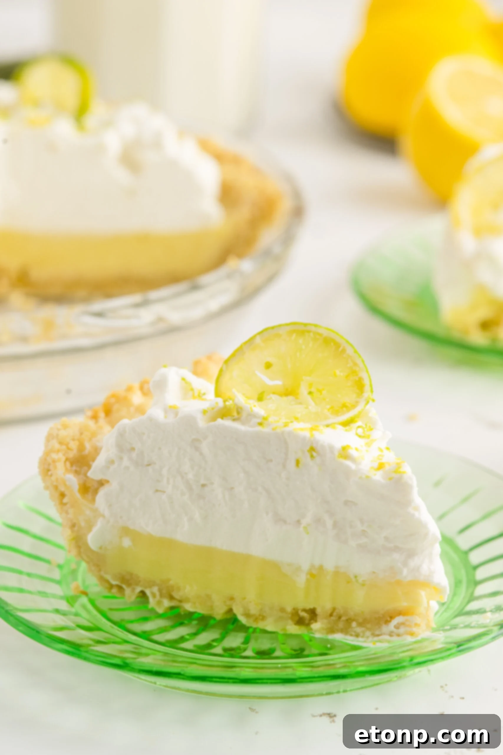 Salty Sweet Coastal Pie 9 A piece of Atlantic Beach Pie on a green plate topped with a fresh lemon.