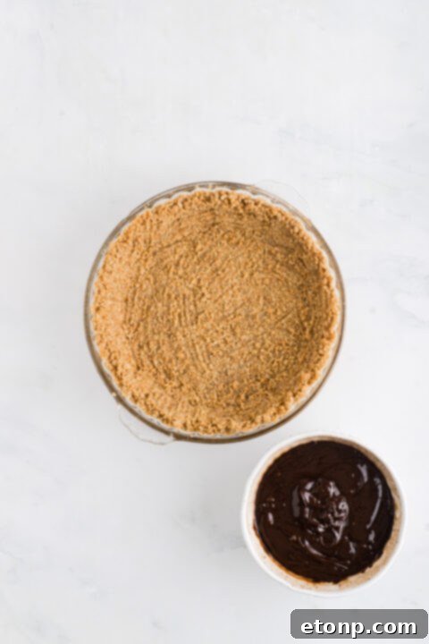 A measuring cup of heavy cream, an ingredient for S'mores pie