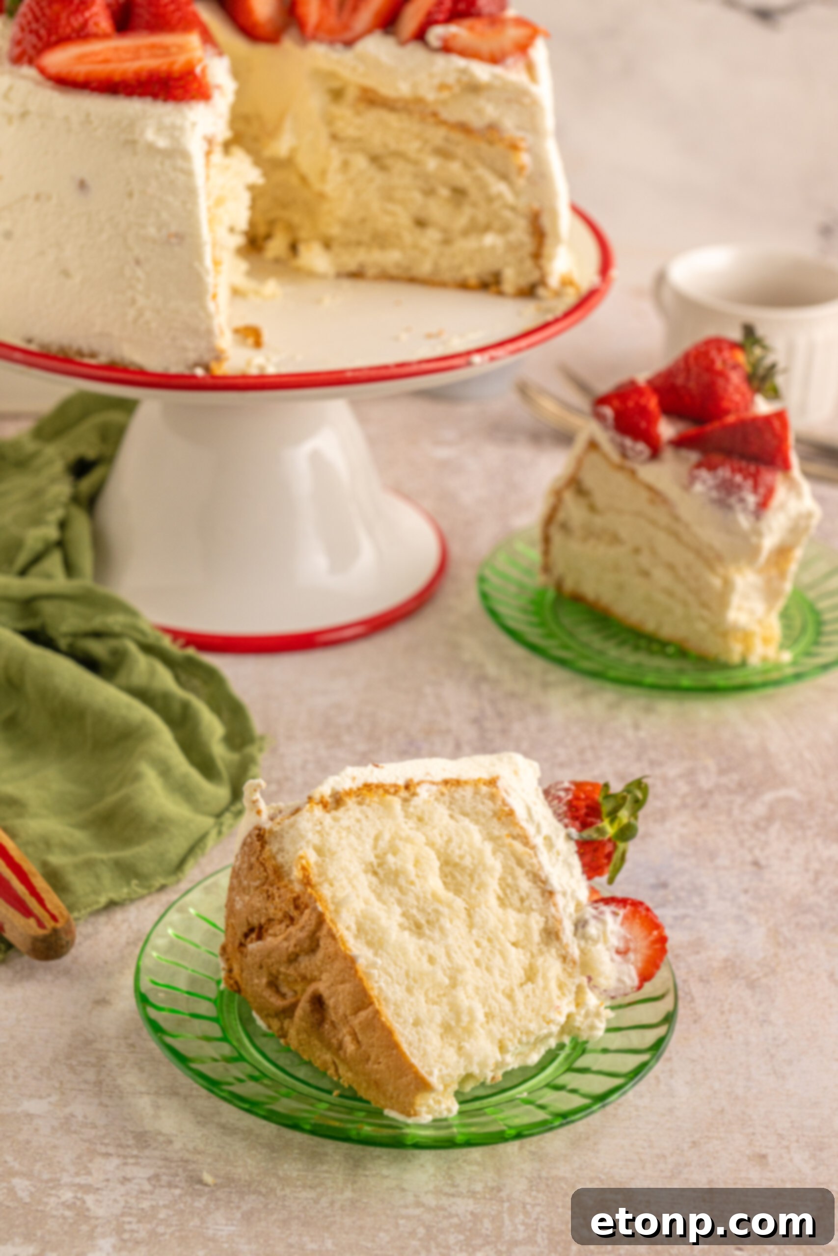 A single piece of Strawberry Angel Food Cake elegantly placed on a vibrant green plate, ready for enjoyment.