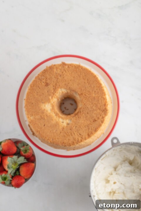 A close-up of granulated sugar being added to the egg whites mixture.