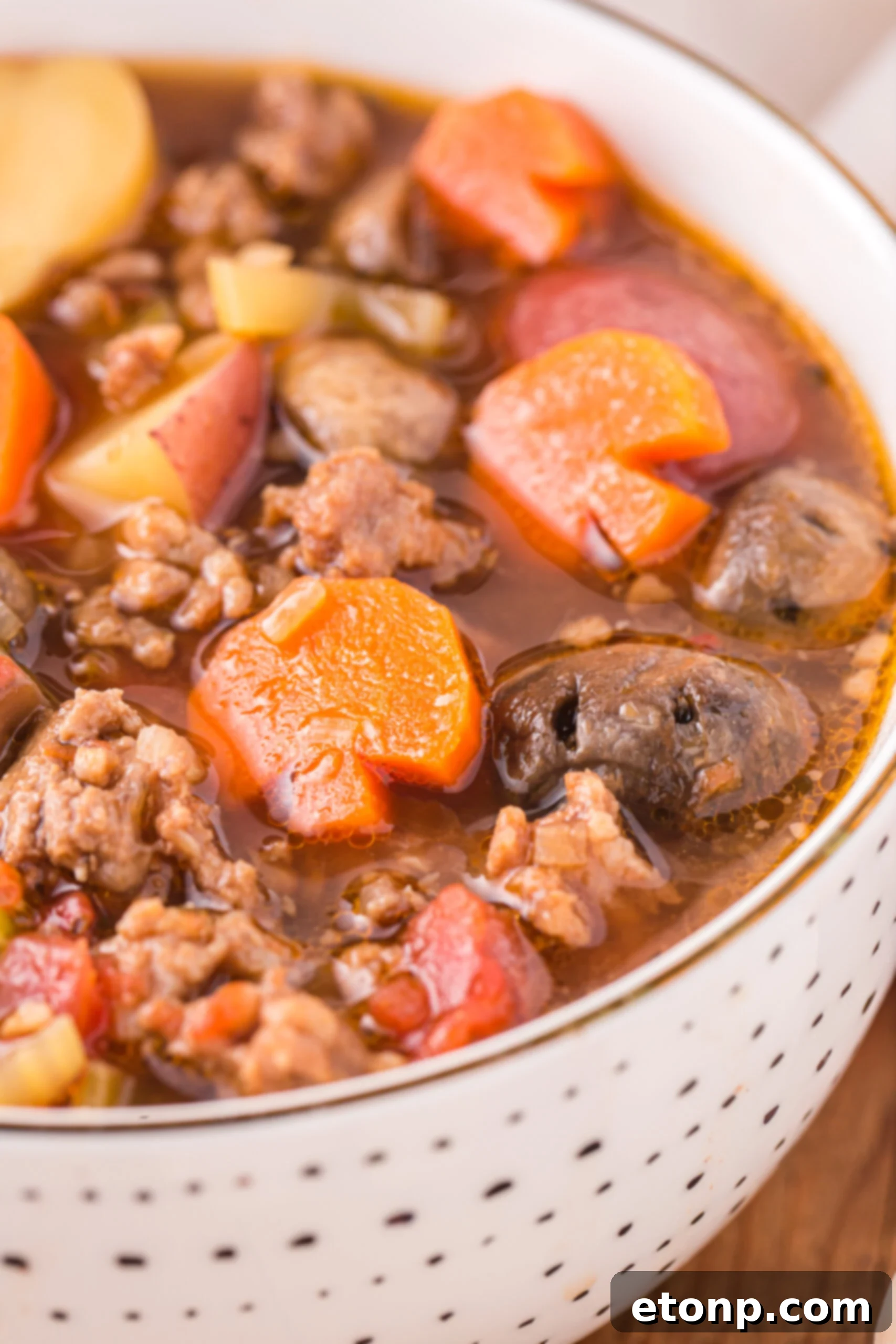 Close up view of a serving of Witches Brew Stew in a bowl.