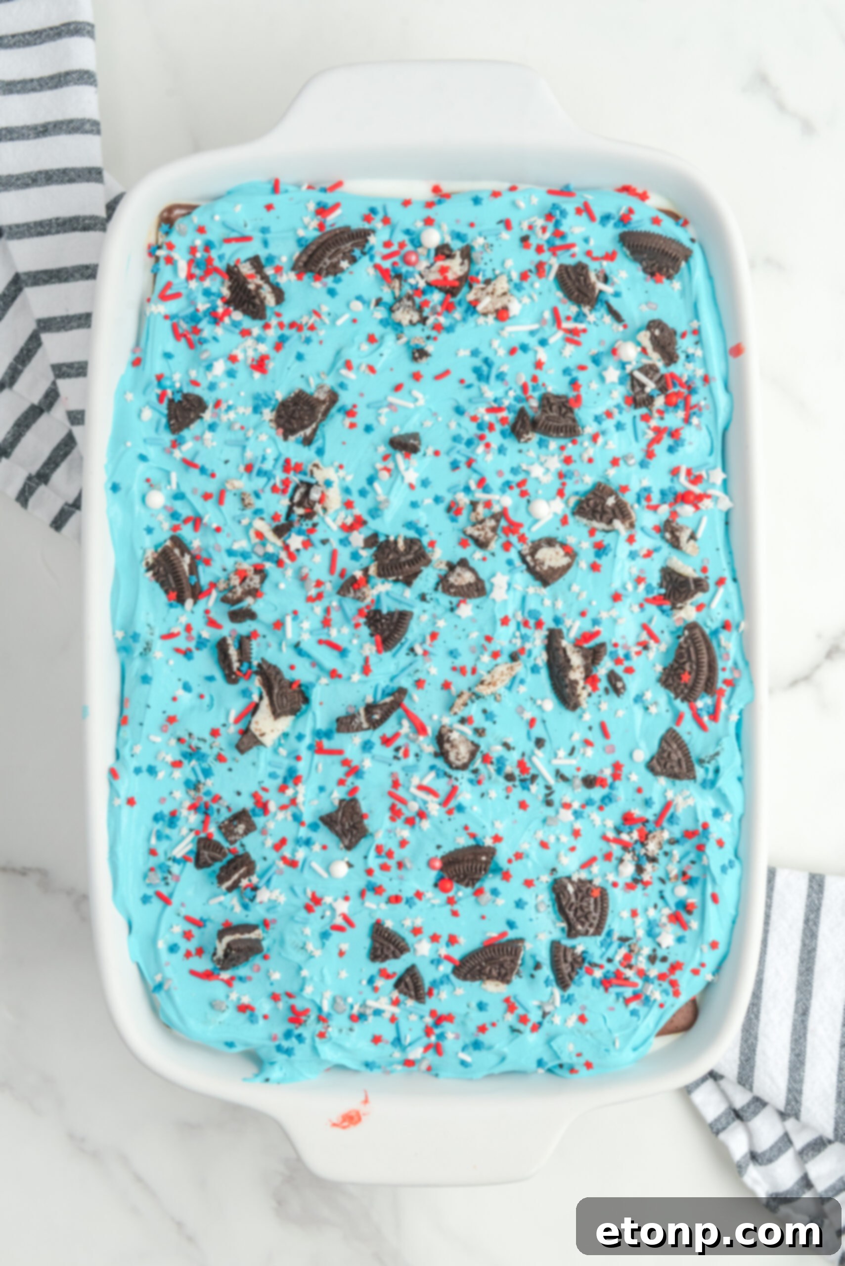 Overhead view of Patriotic Ice Cream Sandwich Cake in a white baking dish.