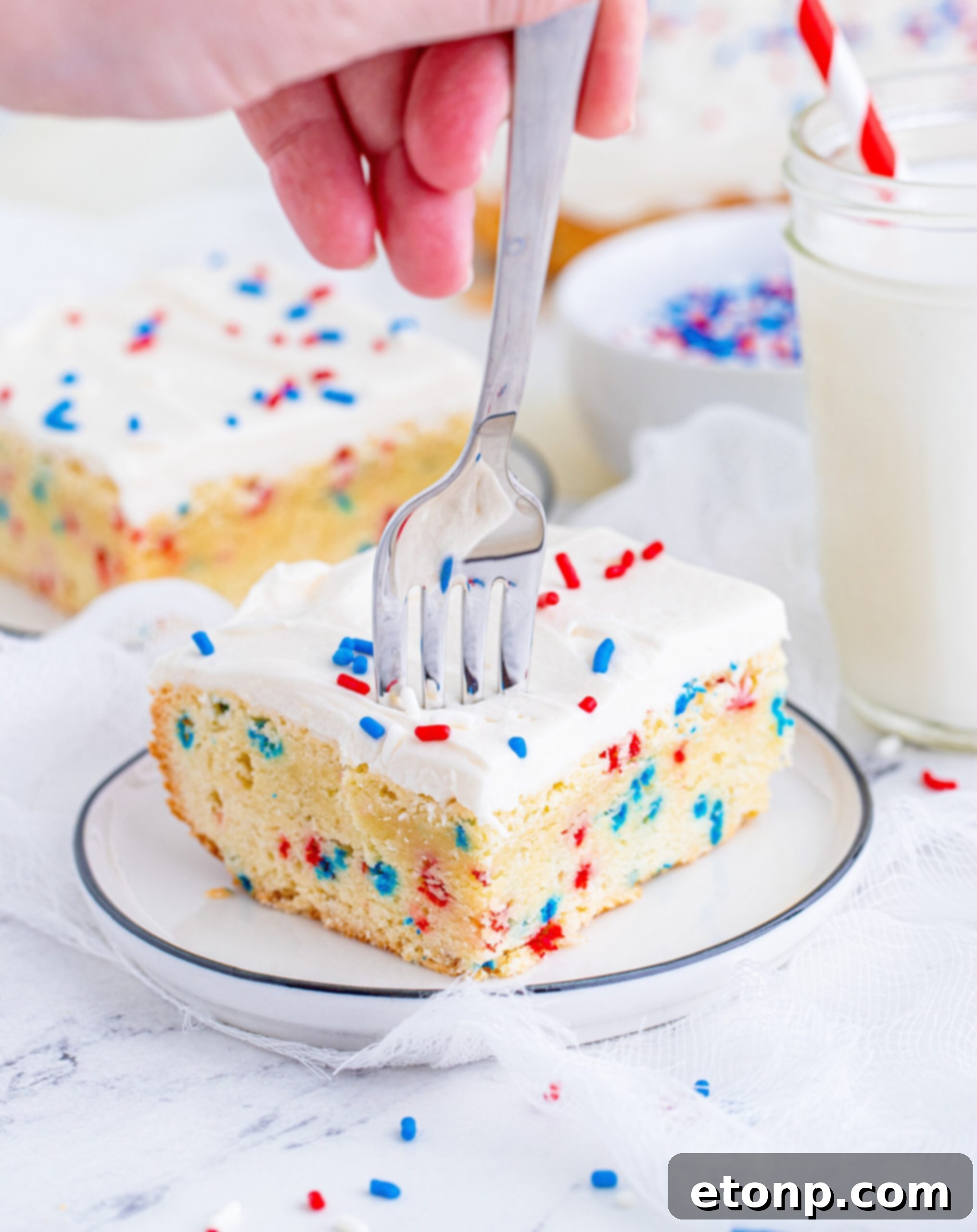 Front view of a silver fork removing a bite from a Patriotic Sugar Cookie Bar.