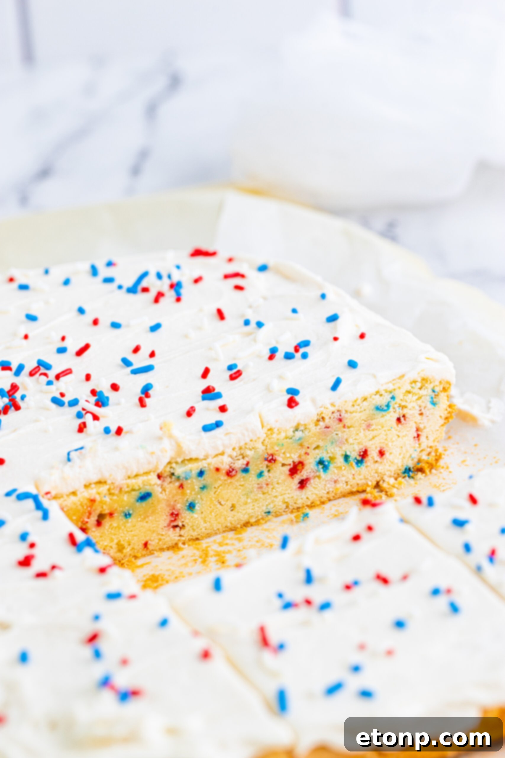 Close up view of Patriotic Sugar Cookie Bars with two pieces removed.