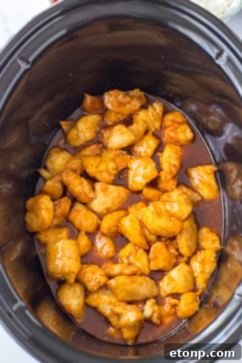 Mixing bowl with hot wing sauce, brown sugar, water, and apple cider vinegar being whisked together.