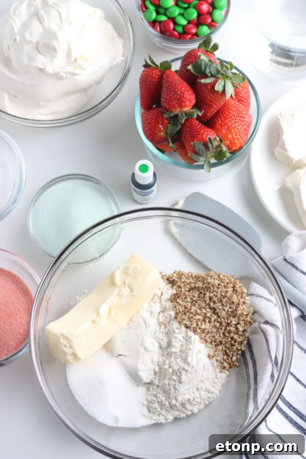 Ingredients for the crisp, buttery crust of the Christmas dessert lasagna laid out on a table, including flour, sugar, nuts, and softened butter.