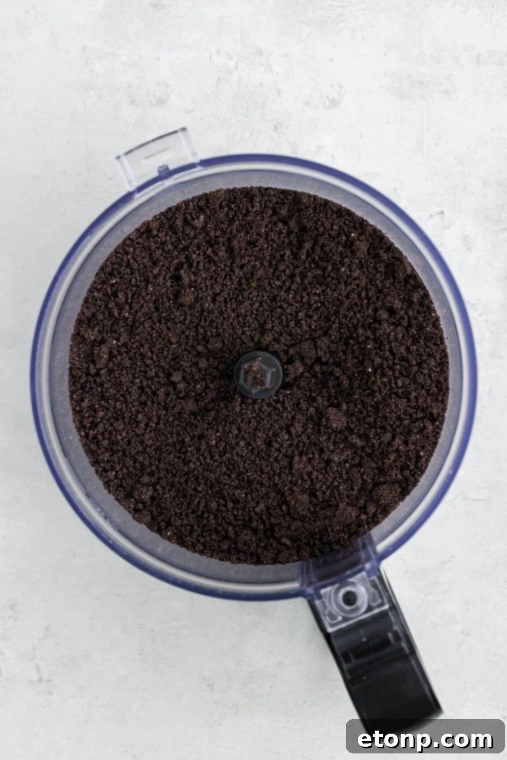 Crushed Oreo cookies in a food processor, ready to be transformed into a delicious truffle base.