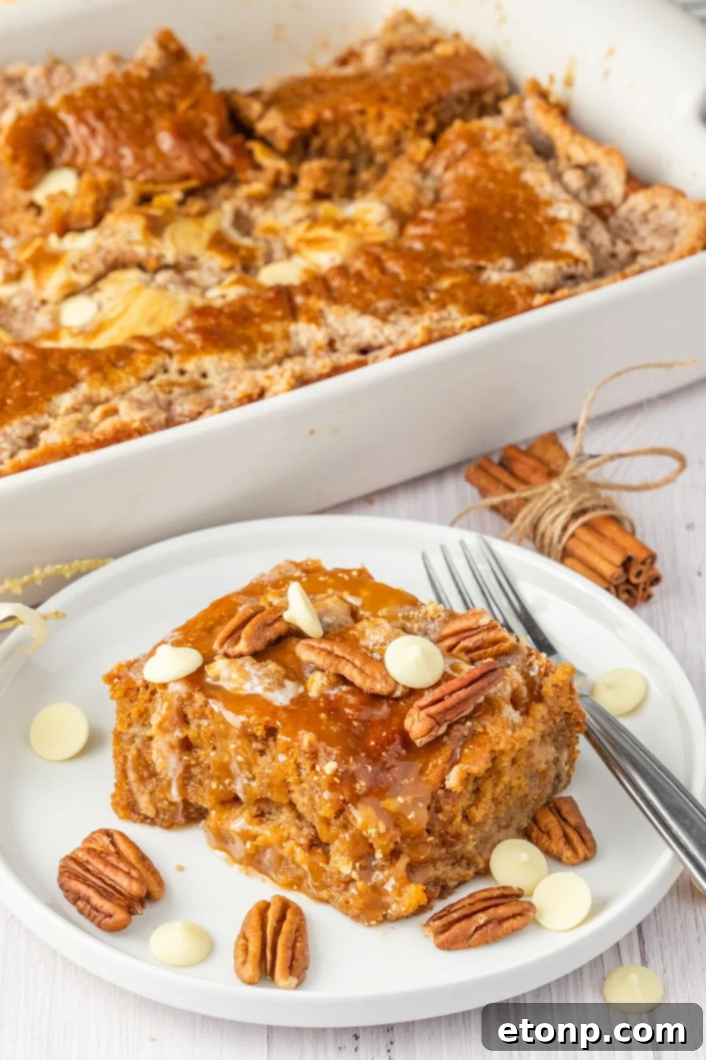 pumpkin cake on plate with nuts around it