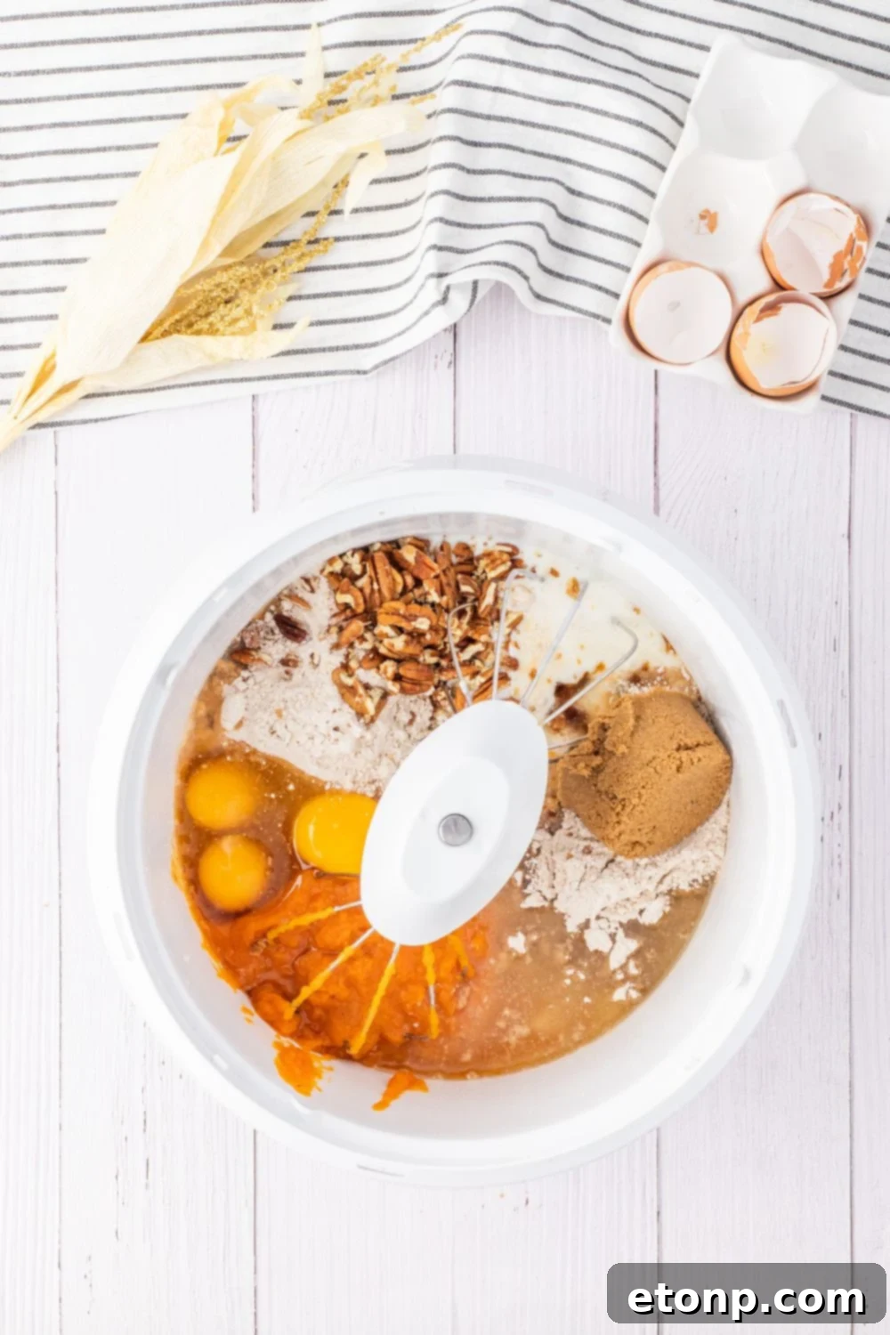ingredients for a pumpkin cake in mixer on table