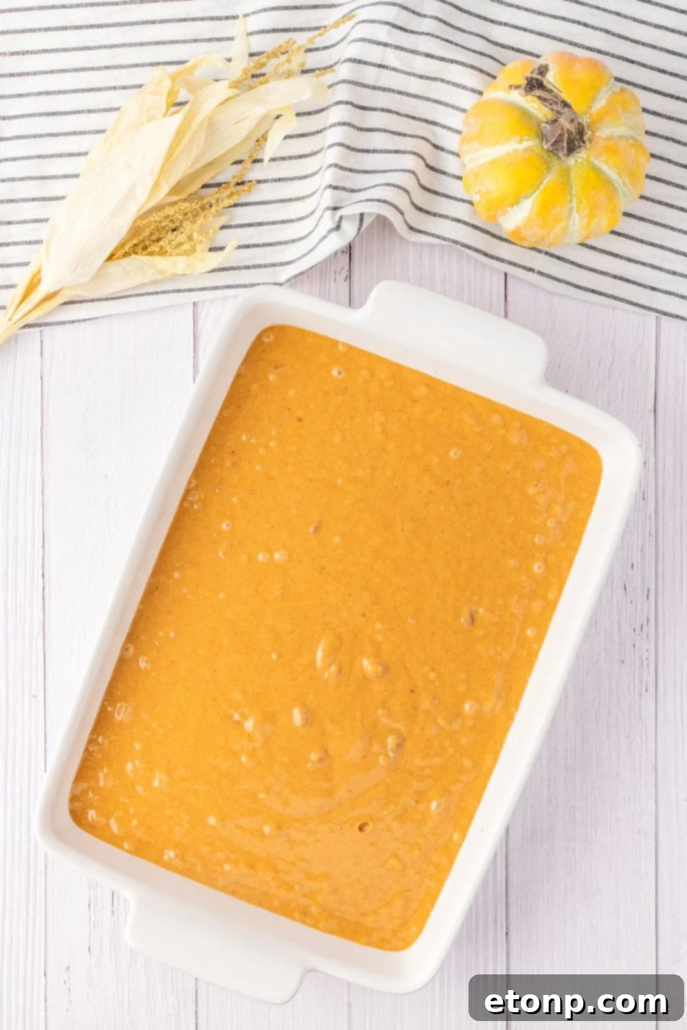 pumpkin cake batter in a baking pan