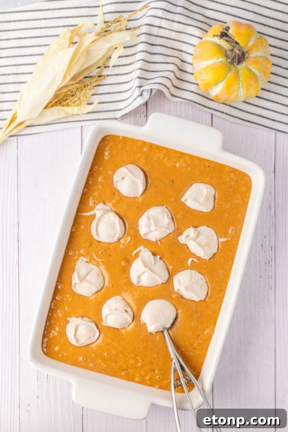 dollops of cream cheese mixture in a cake