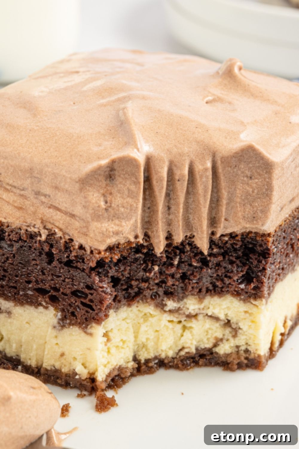 Dolce Vita Cake 17 Italian Love Cake sliced on a plate with a fork after a bite has been taken, showing the delicious layers