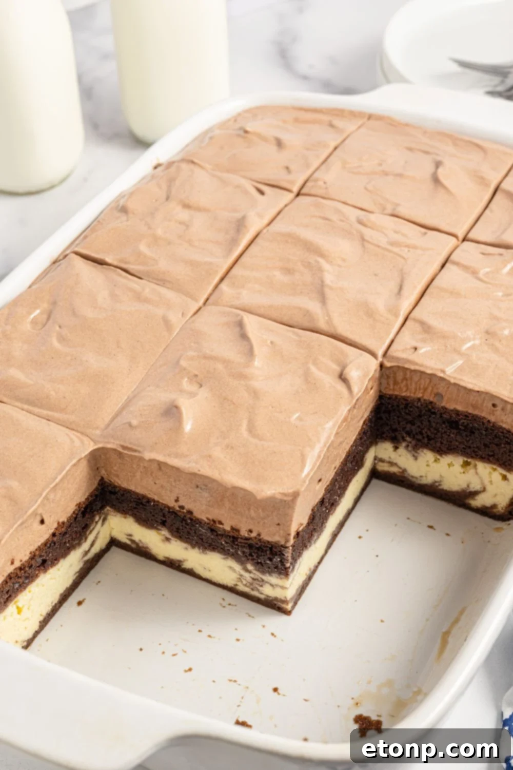 Dolce Vita Cake 3 Italian love cake in baking pan with a few slices removed, revealing the beautiful layers